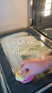 Person cleaning a greasy pan using E&B Dishwashing Paste – cuts through thick oil and residue